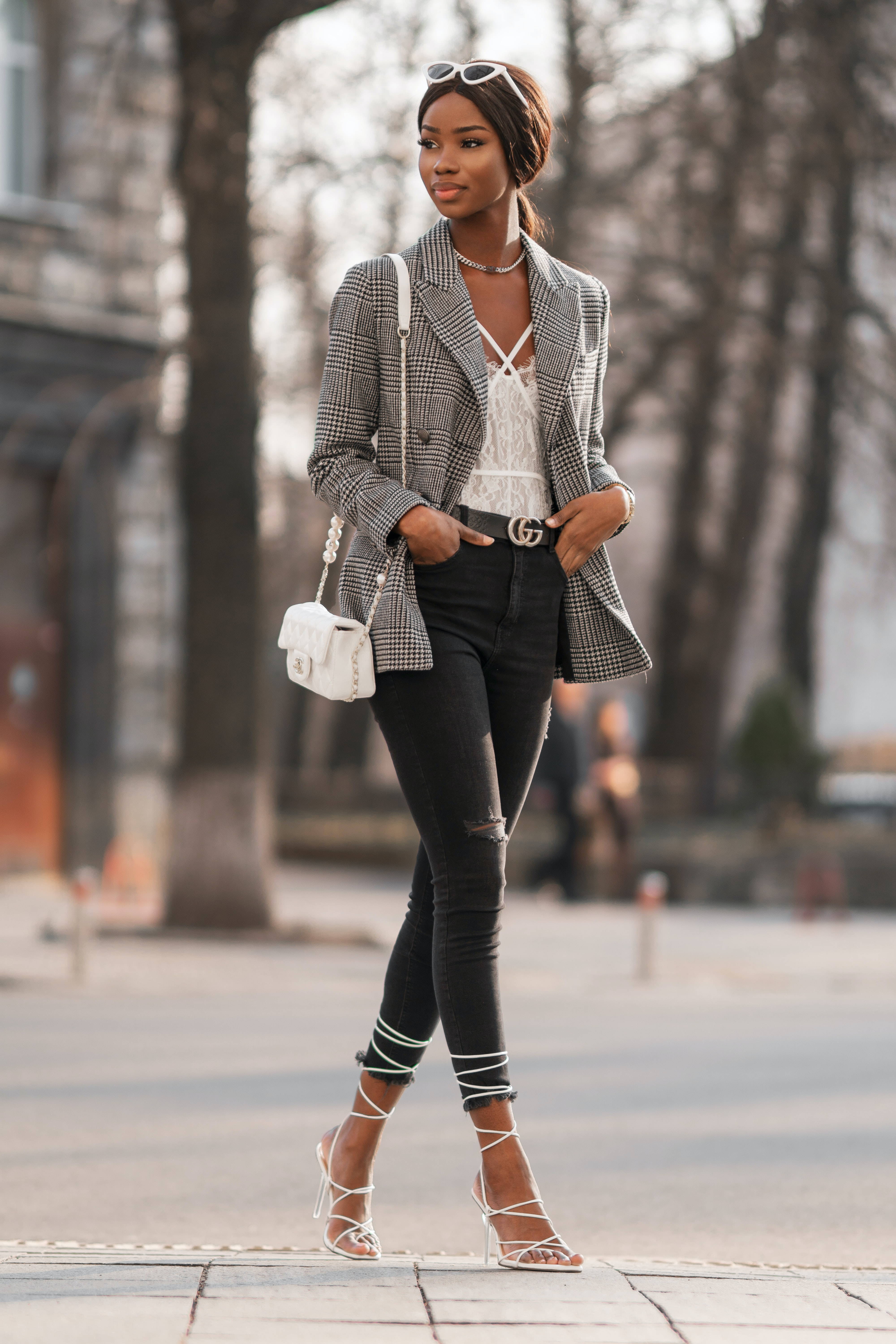 Image of a woman standing wearing a black and white jacket.